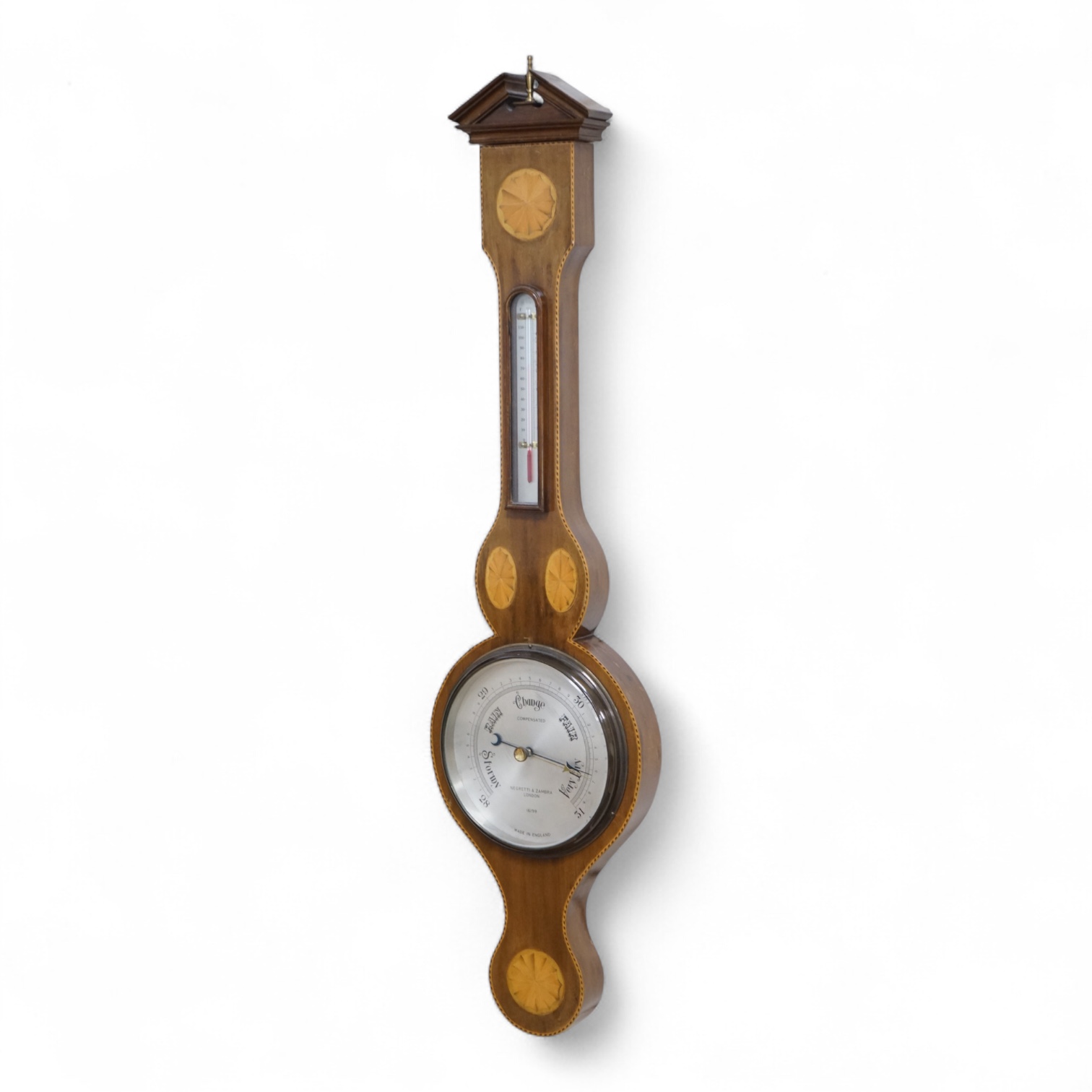 An Edwardian style inlaid mahogany Negretti & Zambra wheel barometer / thermometer, 82cm high